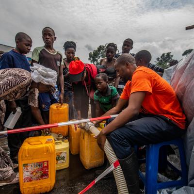 People filling jerry cans with water at MSF centre in Sake, DRC