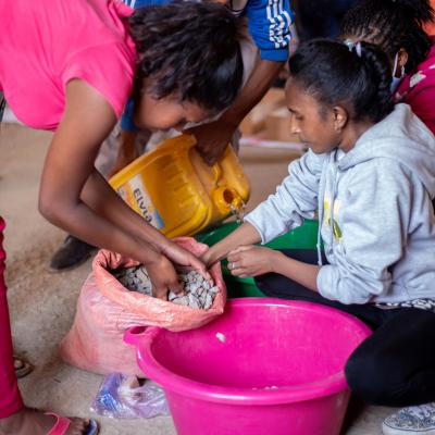 Girls in Madagascar making an artisanal water filter