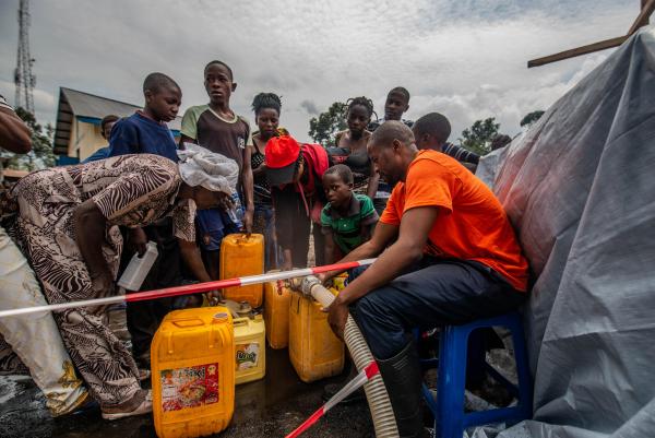 People filling jerry cans with water at MSF centre in Sake, DRC